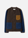 A male model wearing the Brown/Indigo Wool Fleece Cardigan against a plain studio background. The front shot showcases the five-button placket, v-neck cut, chest pocket, and unique two-tone brown and indigo knit texture.