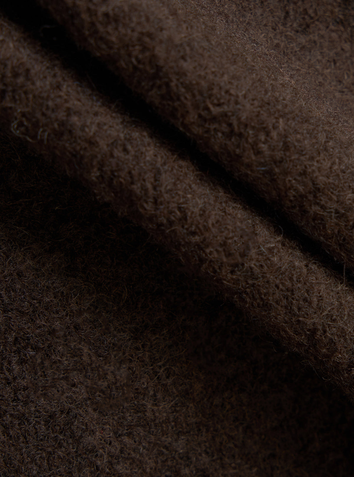 A square fabric swatch image of the Brown/Indigo Wool Fleece Cardigan on a plain background, focusing on the rich combination of brown and indigo fibers woven together into a warm wool fleece blend.