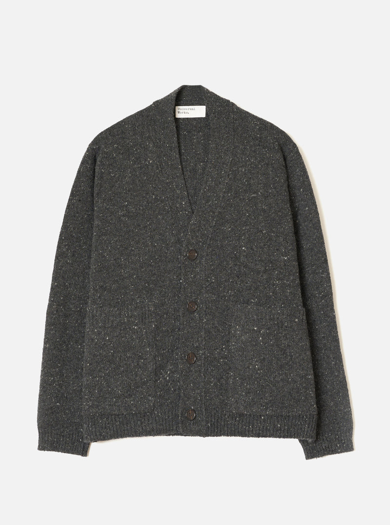 A male model wearing the Black Wool Fleck Langdale Cardigan set against a plain light background. The front view showcases the buttoned front closure, patch pockets, V-neckline, and specked wool fleck pattern.