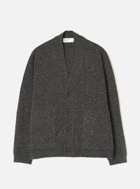 A male model wearing the Black Wool Fleck Langdale Cardigan set against a plain light background. The front view showcases the buttoned front closure, patch pockets, V-neckline, and specked wool fleck pattern.