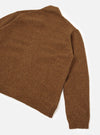 A rear view of a male model wearing the Brown Wool Fleck Langdale Cardigan against a plain studio background, showcasing the back panel construction, comfortable boxy cut, and rich brown flecked texture.