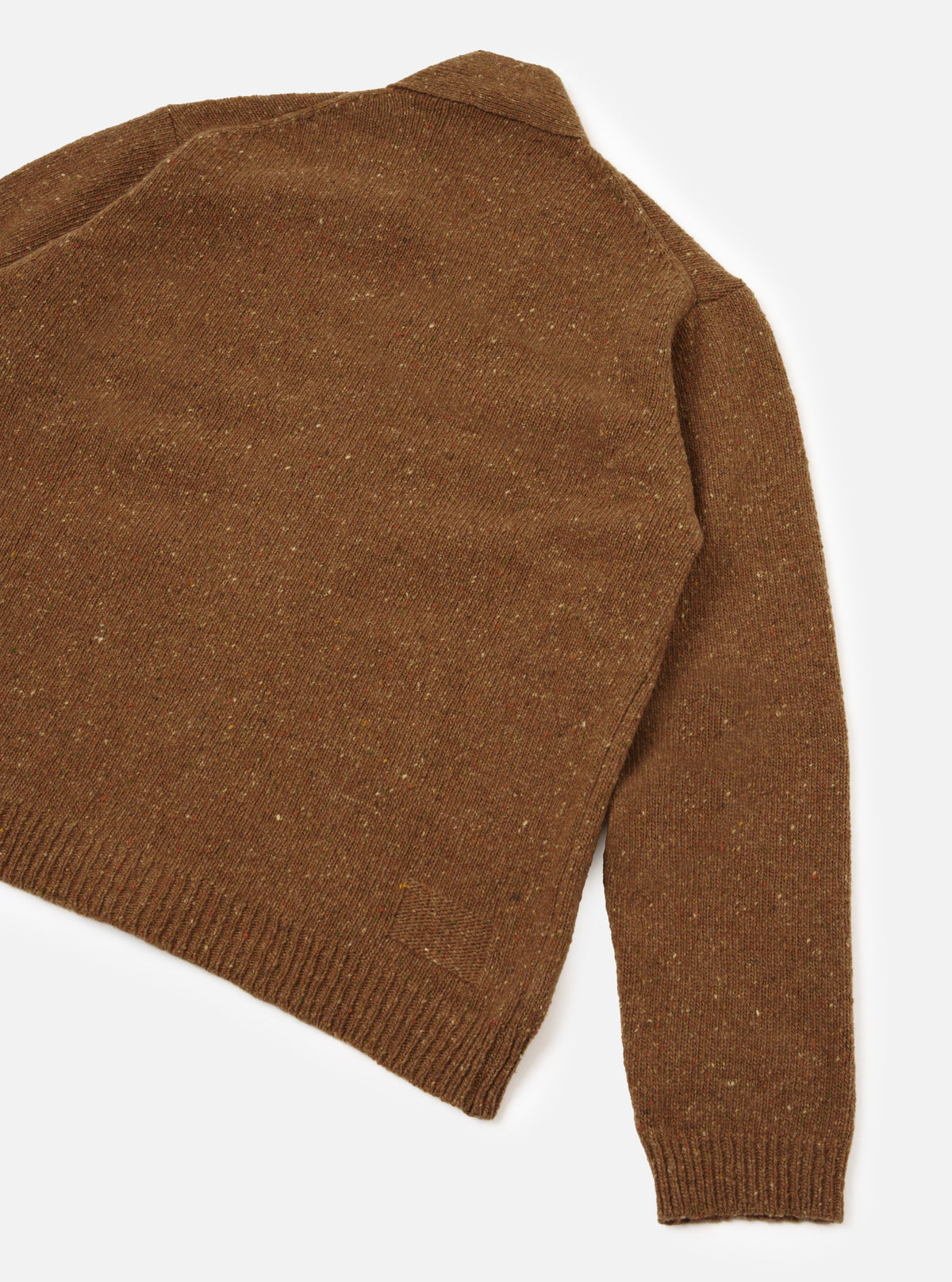 A rear view of a male model wearing the Brown Wool Fleck Langdale Cardigan against a plain studio background, showcasing the back panel construction, comfortable boxy cut, and rich brown flecked texture.