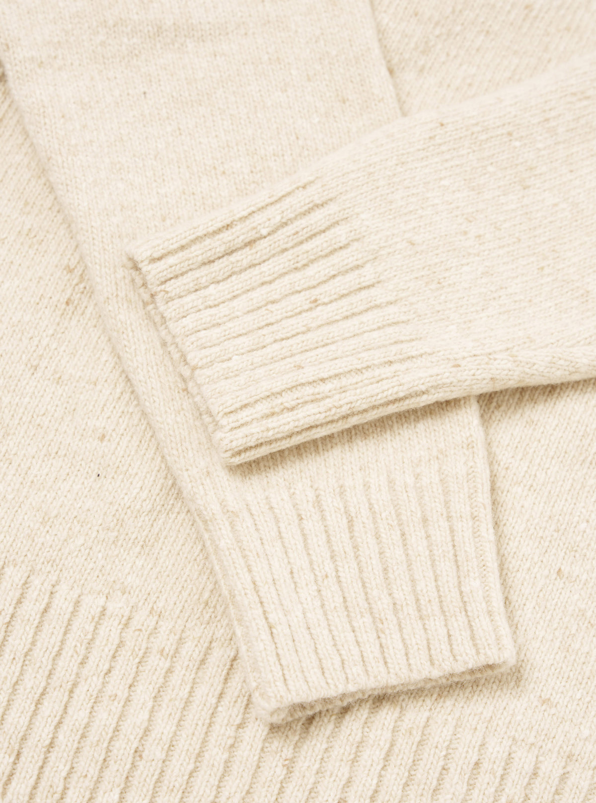 A detailed close-up image of the Fawn Wool Fleck Roll Neck collar, displaying the intricate ribbed knit structure and soft recycled wool texture accented with subtle multi-colored flecks.