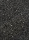 A close-up fabric swatch image of the Black Wool Fleck Sweater Vest material, illustrating the rich black shade, detailed knitted weave, and subtle contrasting fleck accents on a plain backdrop.