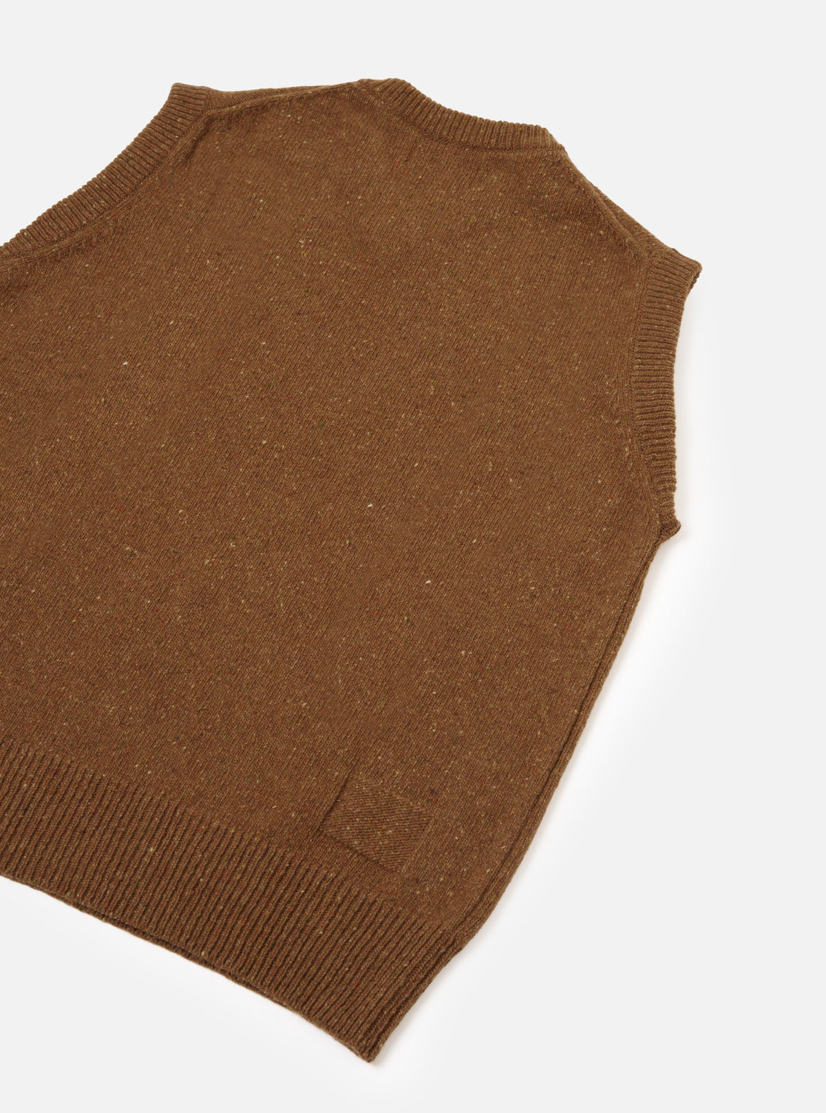 A back view of a model wearing the Brown Wool Fleck Sweater Vest on a light plain background, demonstrating the relaxed fit, classic sleeveless style, and soft flecked recycled wool construction.