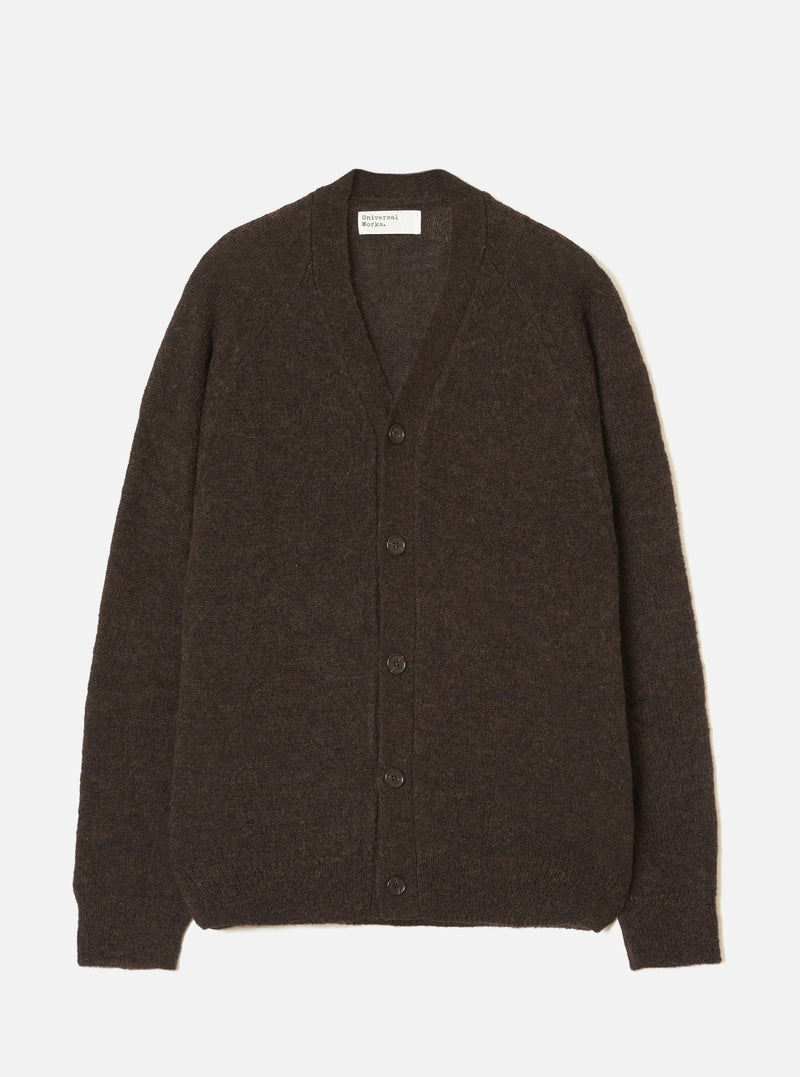 A model wearing the Brown Alpaca Knit David Cardigan against a plain light studio background. The cardigan features a button-front closure, classic v-neckline, patch pockets, and a soft alpaca blend texture.