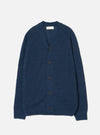 Navy alpaca knit cardigan laid flat on a light grey seamless backdrop. Features a V-neckline, raglan sleeves, and five dark brown buttons down the centre front. Ribbed cuffs and hem visible. The fluffy, brushed texture of the alpaca knit is evident across the body. A Universal Works woven label sits at the inner neck.