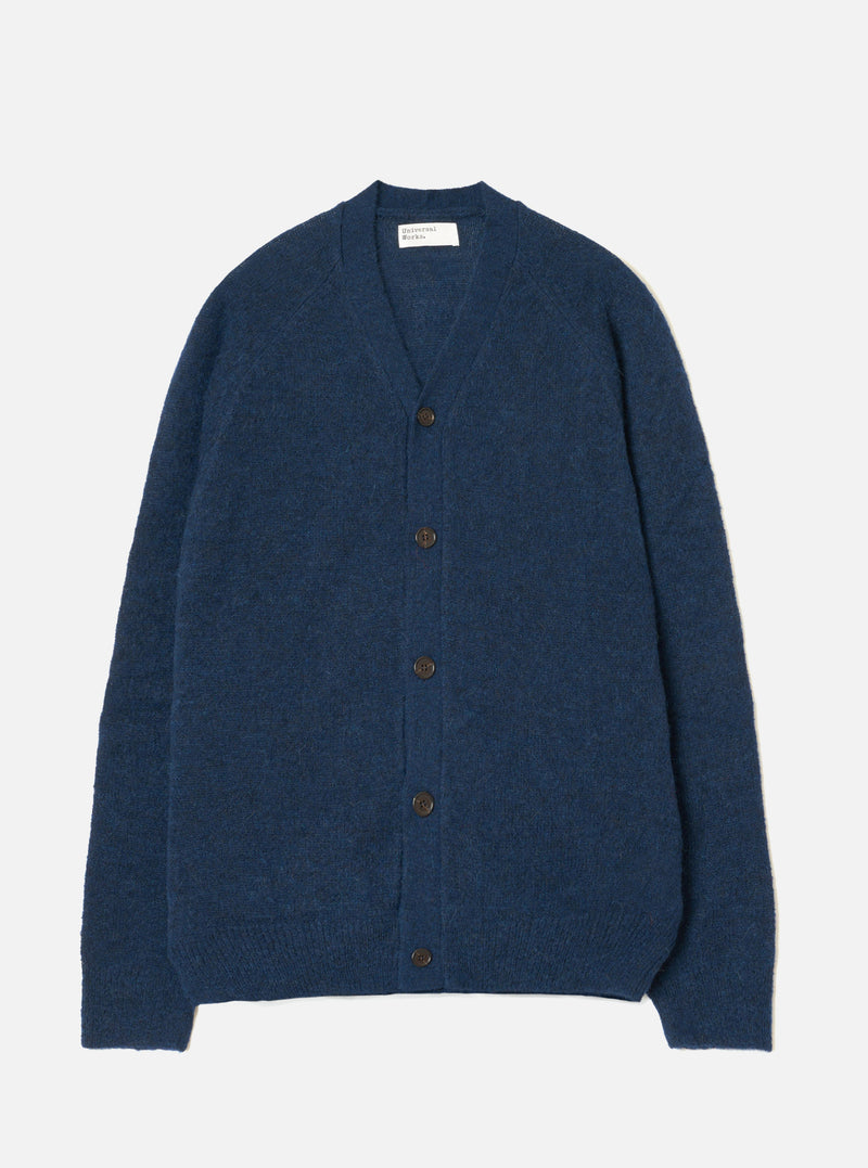 A model wearing the Navy Alpaca Knit David Cardigan against a studio backdrop. The classic cardigan showcases a front button placket, V-neck collar, dual patch pockets, and a soft alpaca blend knit weave.