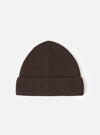 A Brown Merino Knit Watch Cap displayed flat against a plain studio background. The classic knitted beanie features a soft ribbed texture, a turn-up cuff, and a comfortable stretchy fit in rich brown merino wool.