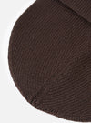 A close-up view of the Brown Merino Knit Watch Cap set against a plain background, focusing on the detailed ribbed knit construction, soft merino wool fibers, and neat finished edging of the turn-up cuff.