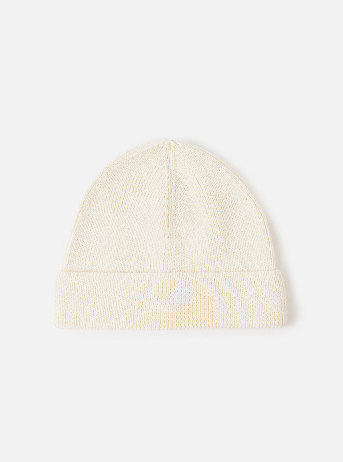 An Ecru Merino Knit Watch Cap displayed flat against a plain studio background. The classic knitted beanie features a soft ribbed texture, a turn-up cuff, and a comfortable stretchy fit in off-white ecru merino wool.