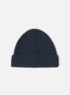 A full view of the Navy Merino Knit Watch Cap displayed against a clean white studio background. The deep navy blue knitted beanie features a thick folded cuff and a classic ribbed pattern throughout.