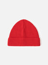 A front-facing view of the Red Merino Knit Watch Cap presented on a plain white studio background. The vibrant red knitted watch cap features a prominent turn-up cuff and uniform ribbed construction.