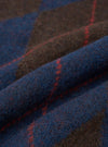 An extreme close-up fabric swatch image of the Navy Alpaca Argyle Lyon Crew material. The photo emphasizes the soft, brushed texture of the alpaca blend knit, showing dark navy fibers woven into a traditional argyle pattern.