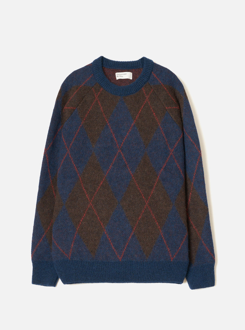 A full front view of the Navy Alpaca Argyle Lyon Crew knit sweater set against a clean white background. The navy blue jumper features a relaxed silhouette, classic crew neckline, ribbed trims, and a distinct argyle diamond pattern.