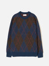 A full front view of the Navy Alpaca Argyle Lyon Crew knit sweater set against a clean white background. The navy blue jumper features a relaxed silhouette, classic crew neckline, ribbed trims, and a distinct argyle diamond pattern.