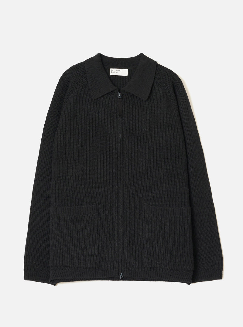 A full front view of the Black Eco Wool Zip Cardigan displayed on a crisp white studio background. The dark grey and black wool knitted cardigan features a full two-way front zip fastening, funnel neck collar, and ribbed hem.