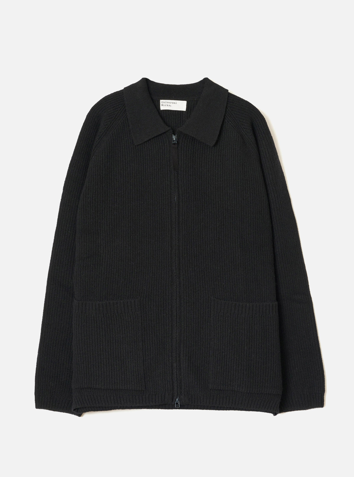 A full front view of the Black Eco Wool Zip Cardigan displayed on a crisp white studio background. The dark grey and black wool knitted cardigan features a full two-way front zip fastening, funnel neck collar, and ribbed hem.