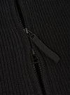 A close-up detail view of the Black Eco Wool Zip Cardigan set against a white background. The image focuses on the textured eco wool fabric, silver-tone zipper puller, high collar construction, and neatly finished zip track.