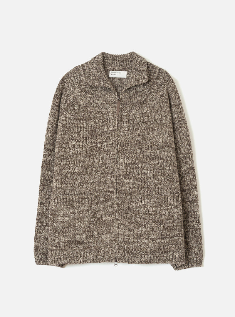 A full front view of the Ecru/Brown Lambswool Zip Cardigan against a stark white background. The soft lambswool cardigan features contrasting ecru off-white and brown tones, a full metal zip closure, and a cozy high collar.