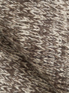 An extreme close-up fabric swatch shot of the Ecru/Brown Lambswool Zip Cardigan. The photo details the thick, warm texture of pure lambswool yarn, showcasing blended ecru and brown fibers knitted together into a soft fabric.