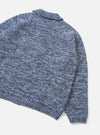 Back view of the Sky/Navy Lambswool Zip Cardigan on a plain white studio background. The knitwear item features raglan sleeves, a fully fashioned collar, and a blue and navy marled lambswool texture.