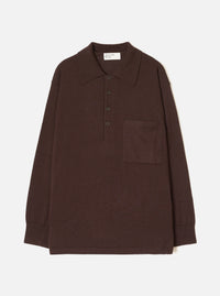 Espresso brown merino knit pullover shirt laid flat on a white studio backdrop. Features a pointed polo collar, four-button placket, single patch chest pocket, long sleeves with ribbed cuffs, and a ribbed hem. Universal Works woven label visible at the back neck.