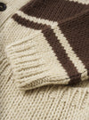 Close-up detail view of the Ecru Chunky Knit Stripe Langdale Cardigan against a plain white background. Highlights the front button closure, V-neck, front patch pocket, and detailed horizontal striped intarsia wool knit pattern.