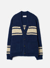 Front view of the Navy Chunky Knit Stripe Langdale Cardigan on a plain white background. Displays the four-button placket, deep V-neck, twin patch pockets, and horizontal intarsia stripe design on heavy navy blue chunky wool knit.
