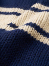 A close-up fabric swatch of the Navy Chunky Knit Stripe Langdale Cardigan. The texture view highlights the dense knit construction, heavy wool yarn, and contrasting intarsia stripe pattern set against a plain white background.