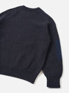 Back view of the Navy British Wool Lyon Crew sweater set on a clean white studio background. Showcases the relaxed fit design, seamless raglan shoulder seams, and textured marled navy British wool construction throughout the garment.