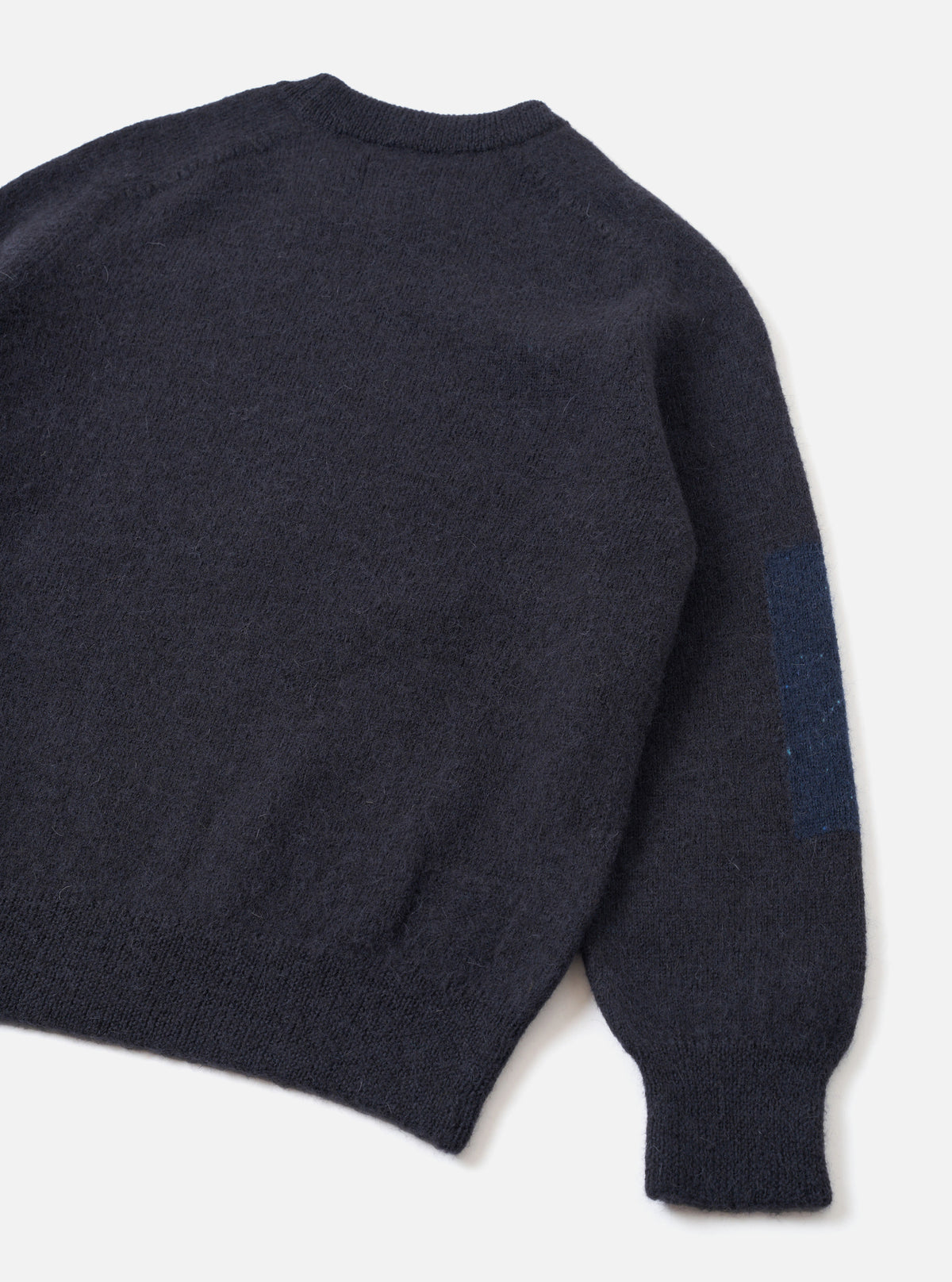 Back view of the Navy British Wool Lyon Crew sweater set on a clean white studio background. Showcases the relaxed fit design, seamless raglan shoulder seams, and textured marled navy British wool construction throughout the garment.