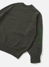Back view of the Olive British Wool Lyon Crew sweater displayed on a plain white studio background. Highlights the comfortable regular fit, raglan sleeve construction, and textured marled olive green British wool fabric.