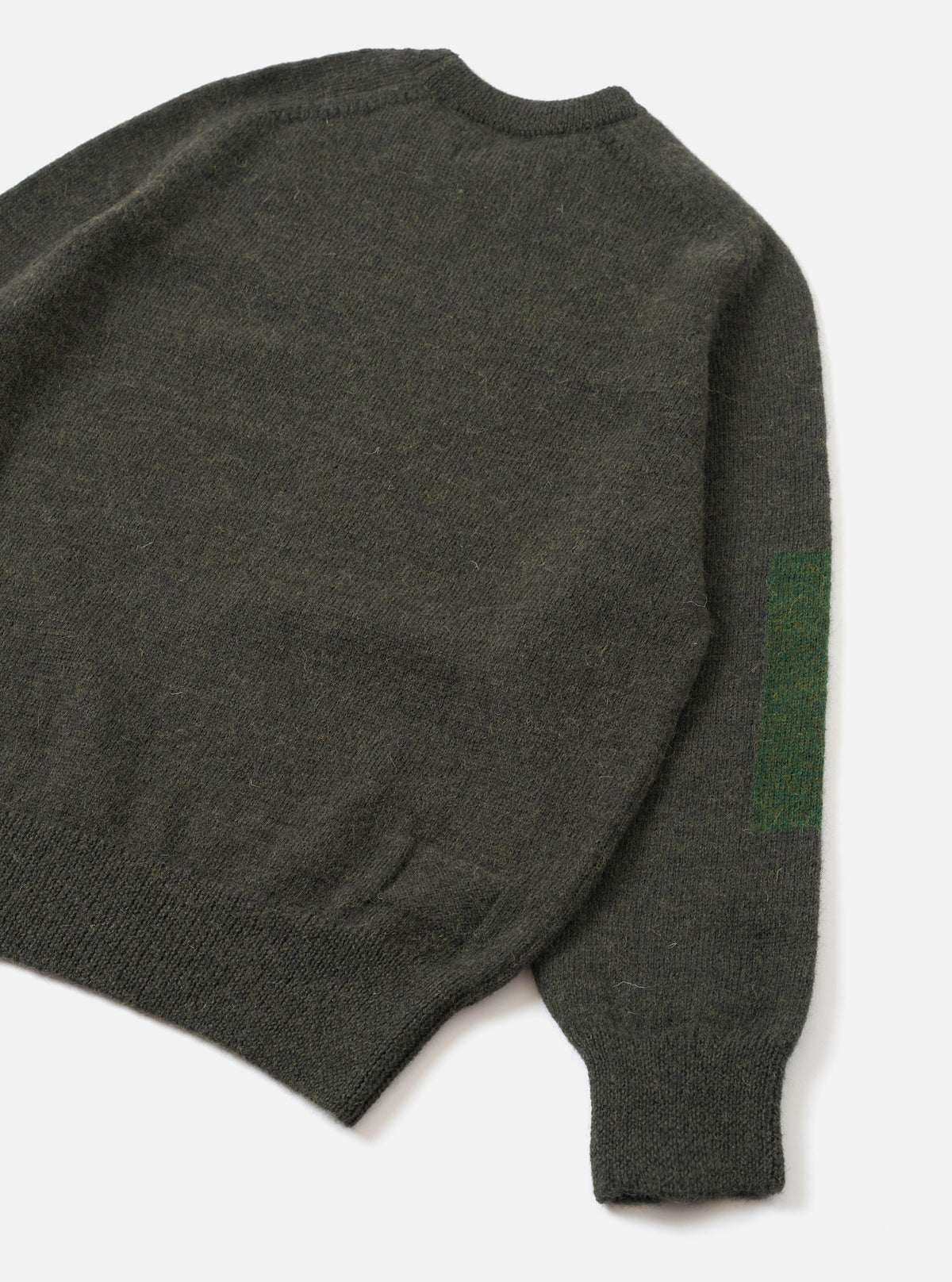 Back view of the Olive British Wool Lyon Crew sweater displayed on a plain white studio background. Highlights the comfortable regular fit, raglan sleeve construction, and textured marled olive green British wool fabric.