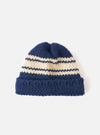 Full view of the Navy Chunky Knit Stripe Lenny Hat set on a plain white studio background. Features a close-fitting beanie style with a thick turned-up cuff, ribbed texture, and a navy blue chunky knit stripe design throughout.