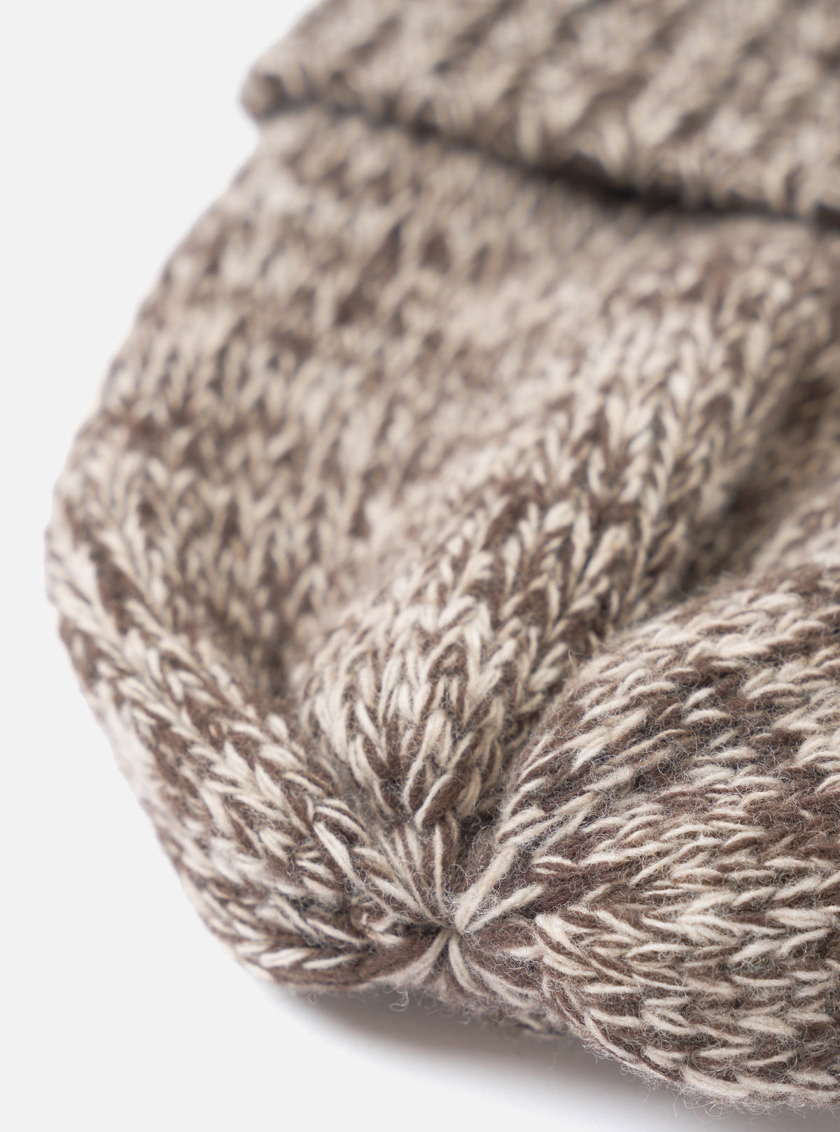 A detailed close-up shot of the Ecru/Brown Lambswool Watch Cap set against a plain white background, highlighting the cozy lambswool knit fabric, fine stitching, and subtle two-tone color pattern.