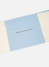 A close-up detail shot of the Ecru/Sky Soft Wool Deluxe Football Scarf against a white background. The focus is on the fine knitted weave of the soft wool material, contrasting color bands, and fringe detailing along the border.