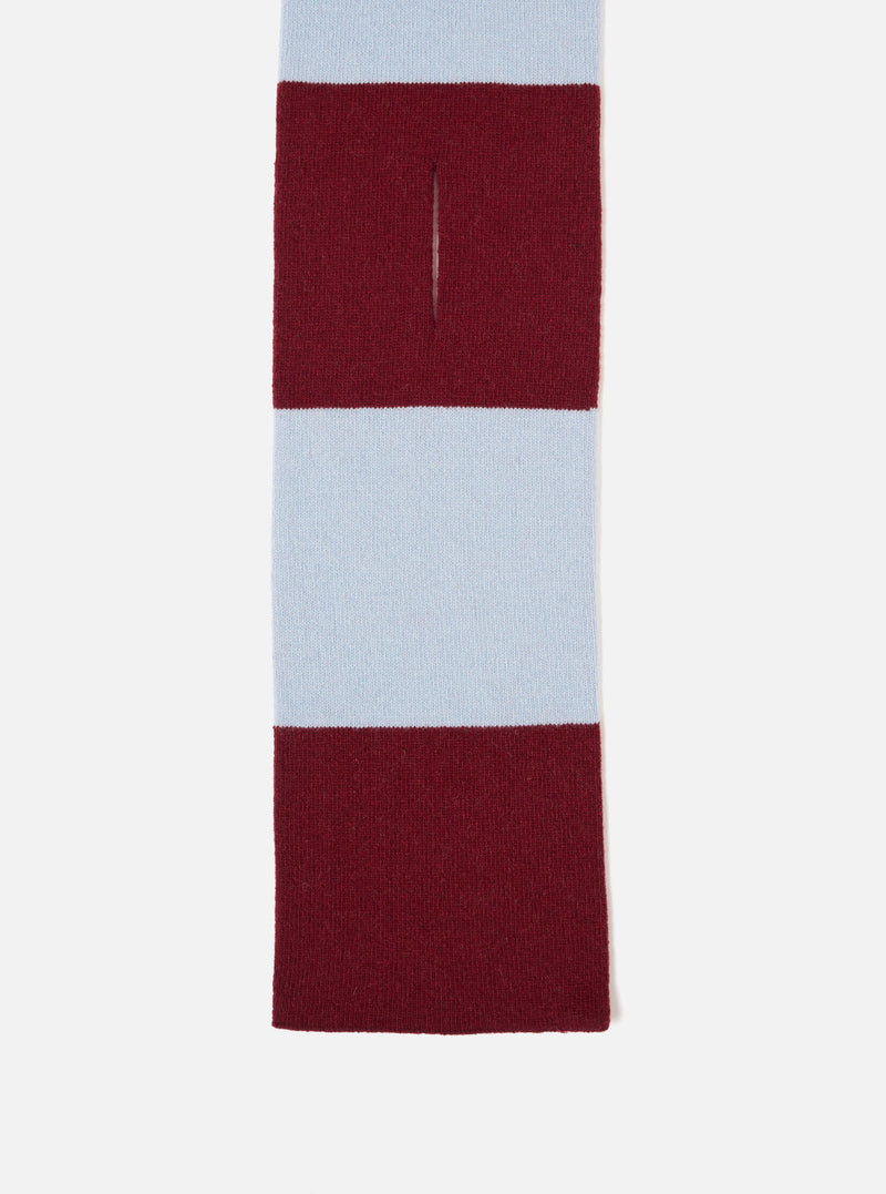 An angled product image of the Sky/Claret Soft Wool Deluxe Football Scarf isolated on a plain white studio background, displaying the contrast between sky blue and deep claret red soft wool knit with fringe trim details.