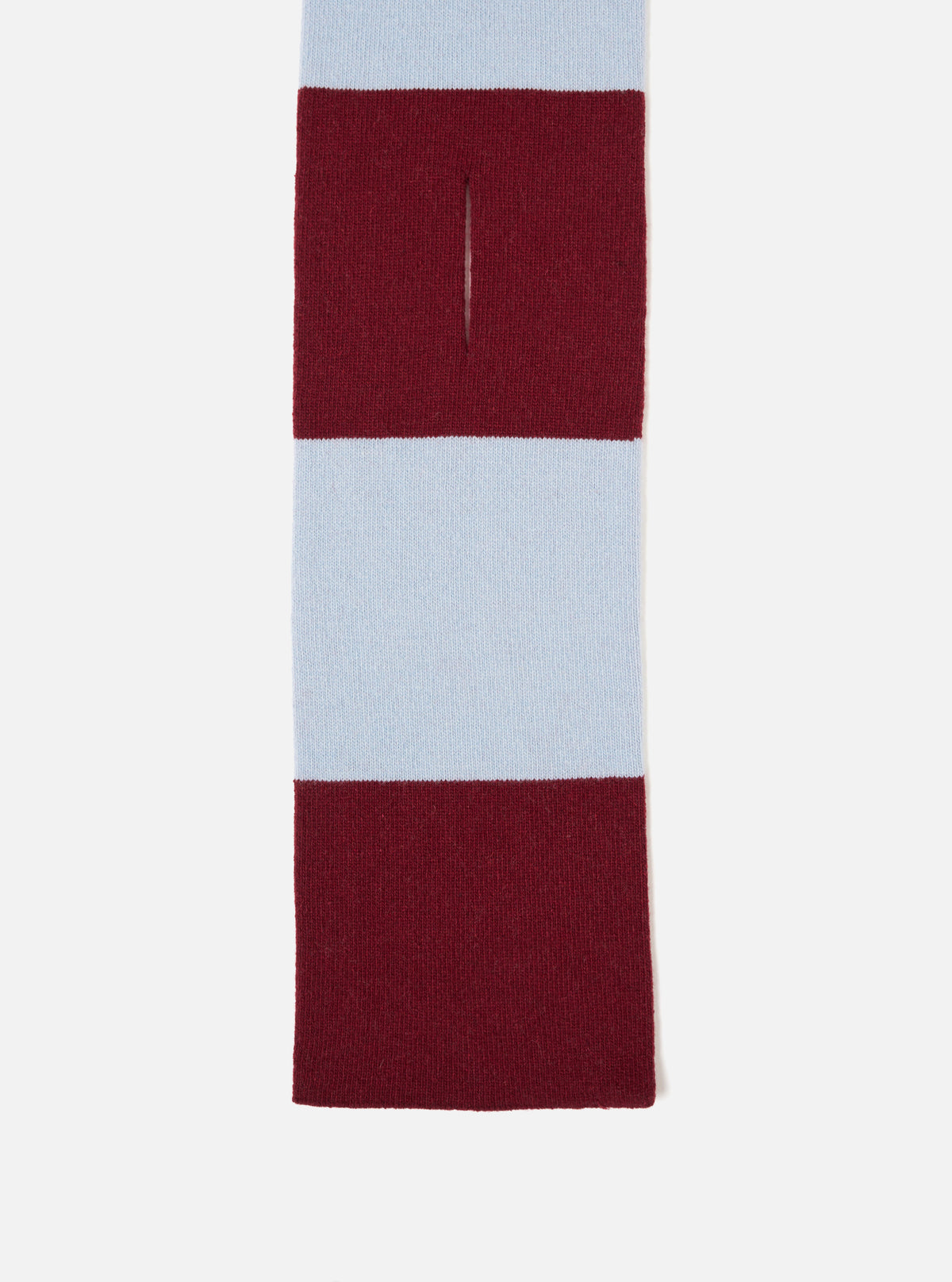 An angled product image of the Sky/Claret Soft Wool Deluxe Football Scarf isolated on a plain white studio background, displaying the contrast between sky blue and deep claret red soft wool knit with fringe trim details.