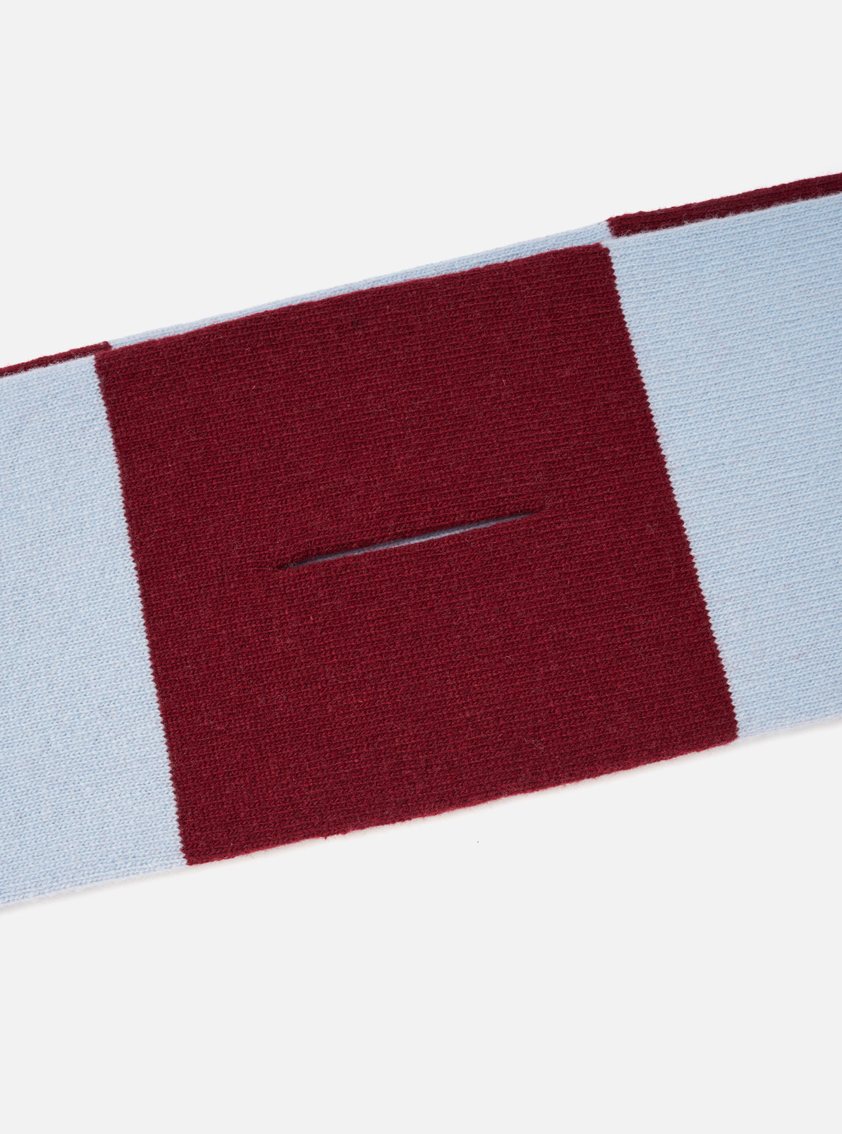 A detailed close-up shot of the Sky/Claret Soft Wool Deluxe Football Scarf set against a solid white background, highlighting the soft knitted wool texture, bold sky blue and claret colorway, and clean fringe craftsmanship.