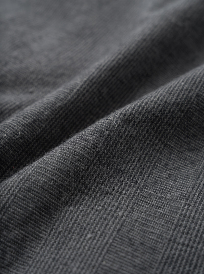 A macro close-up fabric swatch view of the Grey Liverpool Check material against a plain white background, showcasing the fine weave, light grey and dark check pattern, and natural cotton-linen blend texture of the fabric.