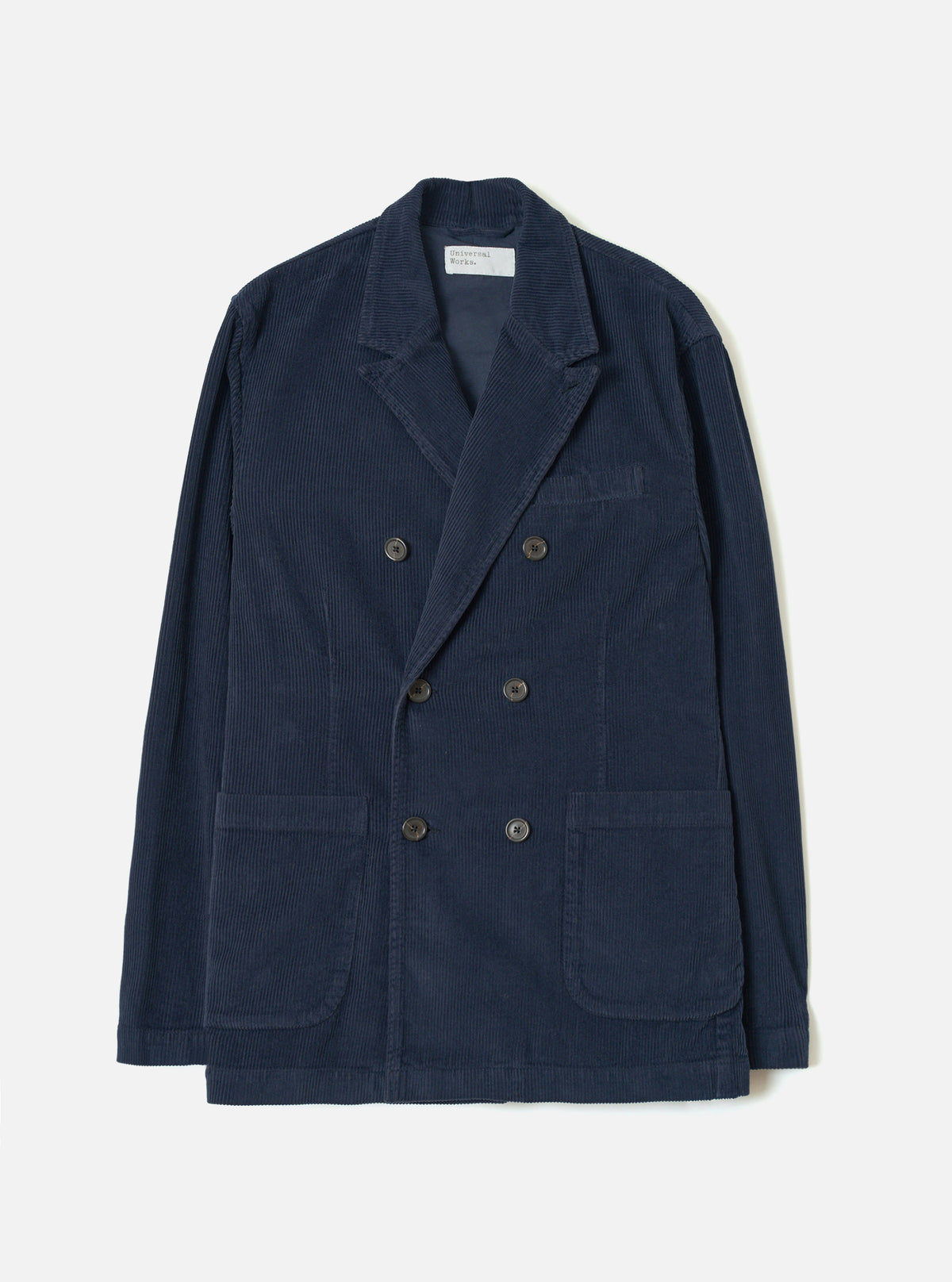 A full front view of the Dark Navy Cord Manor Jacket set against a clean white studio background. The jacket showcases a dark navy blue fine corduroy cotton fabric, buttoned front placket, fold-down collar, and front patch pockets.