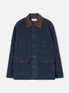Dark navy corduroy utility jacket laid flat on a light grey studio backdrop. Features a contrast brown corduroy collar, five dark horn buttons at the front placket, two chest patch pockets with button flaps, and two larger patch pockets at the hip with button flaps. Woven brand label visible at the neck.