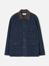 Dark navy corduroy utility jacket laid flat on a light grey studio backdrop. Features a contrast brown corduroy collar, five dark horn buttons at the front placket, two chest patch pockets with button flaps, and two larger patch pockets at the hip with button flaps. Woven brand label visible at the neck.