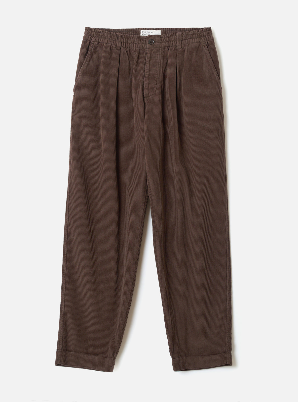 A full front view of the Cacao Cord Pleated Track Pant displayed flat on a plain white studio background. The cacao brown trousers feature a drawstring waist, pleated front detailing, and tapered leg cut.