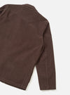 Rear view of the Cacao Cord Three Button Jacket worn by a model against a plain off-white background. The image displays the back paneling, straight hem, single vent, and rich brown corduroy texture of the jacket.
