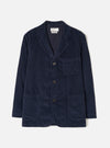 Front view of the Dark Navy Cord Three Button Jacket worn by a model against a plain studio background. The jacket features three front buttons, notch lapels, three open patch pockets, and dark navy cotton corduroy fabric.