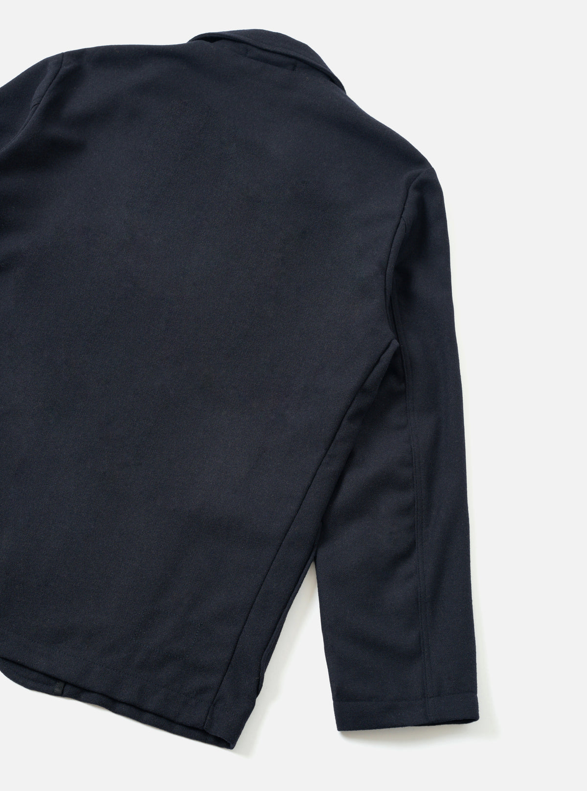 Back view of the Dark Navy Dublin Wool Mix Two Button Jacket worn by a model set against a neutral studio background. The image demonstrates the relaxed fit, structured shoulders, and dark navy woven wool-blend texture.