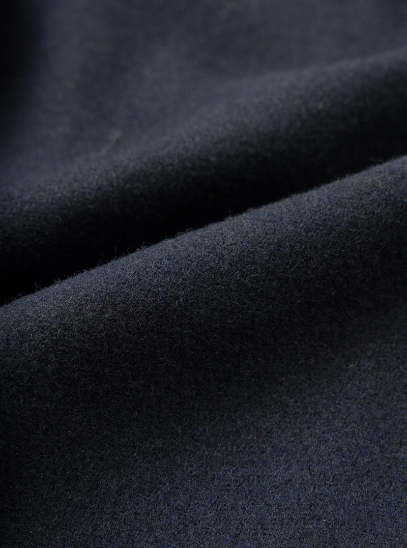Full-frame close-up swatch showing the fabric detail of the Dark Navy Dublin Wool Mix Two Button Jacket. The image highlights the fine woven texture, dark navy heathered weave, and premium wool-blend suiting material.
