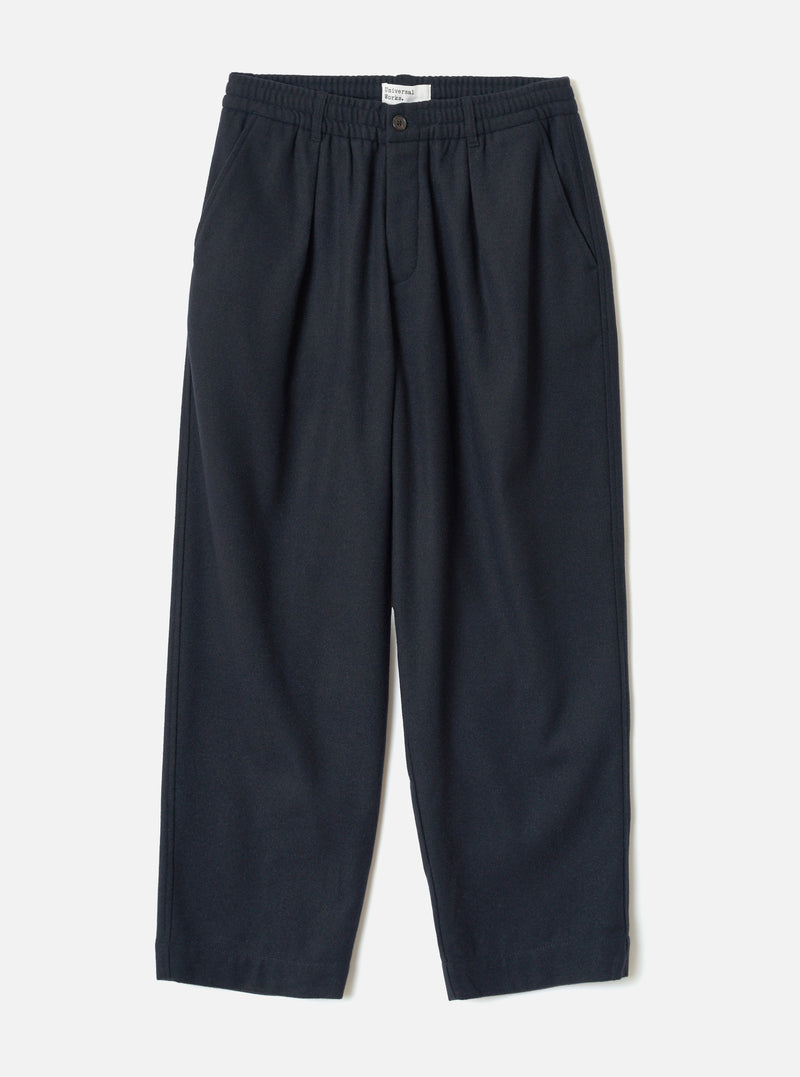 Front view of the Dark Navy Dublin Wool Mix Oxford Pant worn by a model against a plain studio background. The trousers show a wide-leg cut, single front pleats, drawstring waist, and dark navy blue wool-blend fabric.
